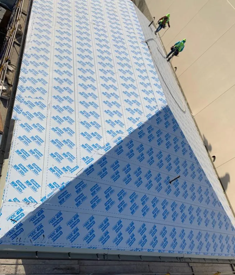 Professional roofers installing underlayment on a metal roof in Vienna